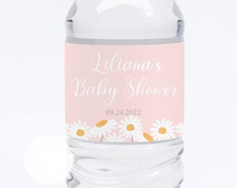 May include: A pink and white water bottle label with a daisy design. The label says "Liliana's Baby Shower" and "09.24.2022".