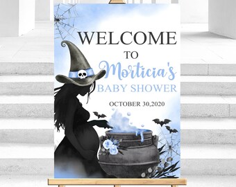 May include: A welcome sign for Morticia's baby shower, featuring a witch silhouette with a hat and a cauldron. The sign has a light blue and black color scheme, with the date October 30, 2020.