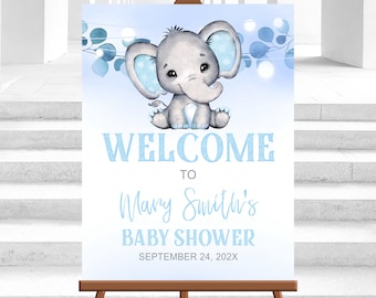 May include: A blue and white baby shower welcome sign with a cute cartoon elephant. The sign says "Welcome to Mary Smith's Baby Shower, September 24, 202X".