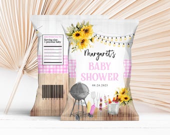 May include: Two chip bags with a baby shower theme. The bags feature a pink gingham pattern, sunflowers, and the text "Margaret's BABY SHOWER 08.24.2023". A barbecue grill and food illustrations are also present.