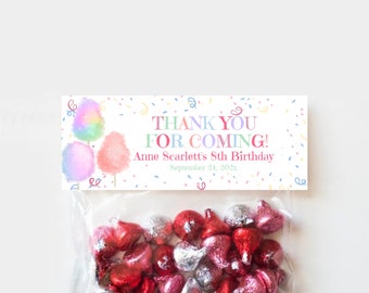 May include: A white thank you favor bag with a pink and blue cotton candy design. The bag has the text "Thank You For Coming!" and "Anne Scarlett's 8th Birthday" with the date "September 24, 2023". The bag is filled with red and silver foil-wrapped chocolate kisses.