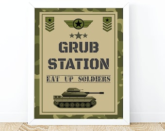 May include: A green and brown camouflage print sign with the text "GRUB STATION EAT UP SOLDIERS" in black. A cartoon green tank is below the text.