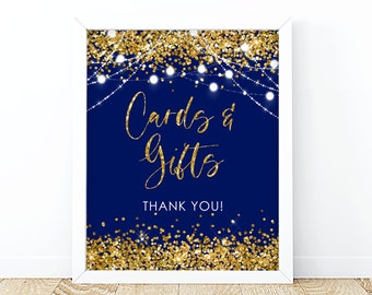 May include: A navy blue sign with gold glitter and white string lights. The sign says "Cards & Gifts" and "Thank You!"