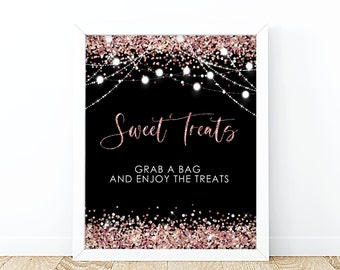 May include: A printable sign with a black background and rose gold glitter. The sign says "Sweet Treats" in a cursive font and "Grab a bag and enjoy the treats" in a sans-serif font. There are white string lights with white bulbs hanging above the text.