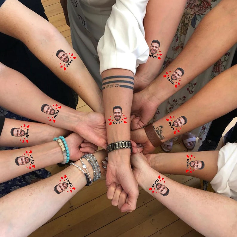 A group of arms with tempory tattoos on for hen and birthday partys