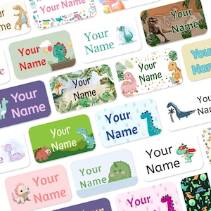 May include: A selection of rectangular name labels, each adorned with dinosaur illustrations. The labels display the text "Your Name" in diverse fonts and colours. The dinosaur designs include a T-Rex and a Stegosaurus, suitable for children's items.
