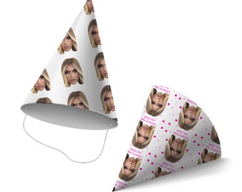May include: Two white party hats with a repeating pattern of a woman's face. The hats have a pink polka dot pattern and the text "Lauren's Hen July 2024".