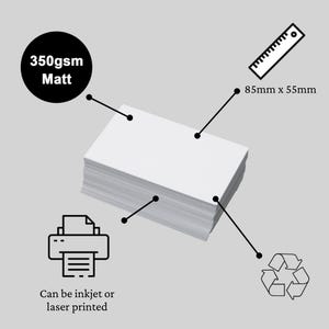 A stack of blank white business cards on a grey background with labels and icons. The card is 85mm x 55mm, made from 350gsm matt paper, and can be inkjet or laser printed. A recycling icon indicates the cards are recyclable.