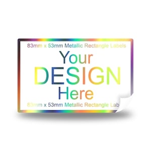 May include: A mockup of a metallic rectangle label with a rainbow iridescent finish. The label is 83mm x 53mm and has the text "Your DESIGN Here" printed on it.