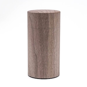 May include: A cylindrical wooden container with a light brown wood grain finish. The container has a smooth, polished surface.