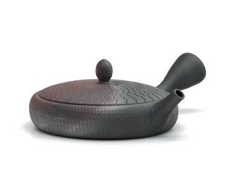 May include: A dark grey ceramic teapot with a textured surface and a lid. The teapot has a side handle and a spout. The lid has a small, round knob. The teapot is designed for brewing tea.