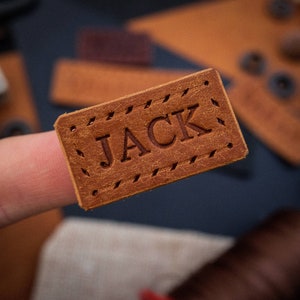 Beautiful small handmade leather label featuring neatly embossed personalisation