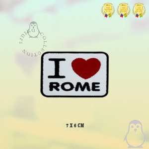 May include: White iron-on patch with the text "I love Rome" in black lettering and a red heart. The patch measures 7 cm by 6 cm.