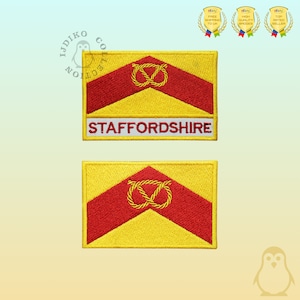 May include: Embroidered patches with a yellow and red design and a knot symbol. One patch has the word "STAFFORDSHIRE" in white. The patches are rectangular with a yellow border.