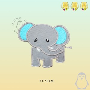 May include: An iron-on patch featuring a cartoon elephant with blue ears. The elephant is embroidered in grey and measures 7 x 7.5 cm.