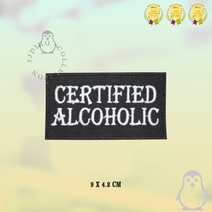 May include: Black embroidered patch with white text that reads "CERTIFIED ALCOHOLIC". The patch is 9 by 4.2 centimetres.