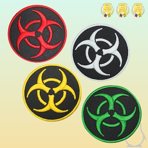 May include: Four embroidered iron-on patches featuring a biohazard symbol in different colours: red, white, yellow, and green. The symbol is a black circle with three stylised crescent shapes.