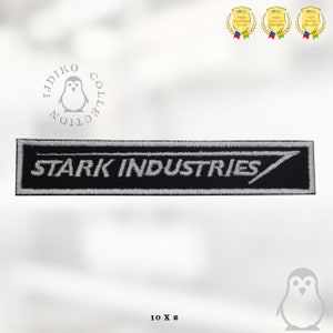 May include: Black and white embroidered patch with the text "STARK INDUSTRIES" in a white font. The patch is rectangular with a white outline and a white diagonal line.