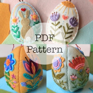 Könnte beinhalten: Vier Filz-Ostereier-Anhänger mit Stickereien. Die Eier sind mit Blumen, einem Hasen und einem Regenbogen verziert. Der Text "PDF Pattern" ist über das Bild gelegt.