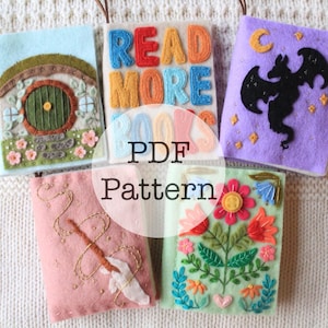 May include: Five felt book covers with embroidery designs. The covers feature a hobbit hole, a dragon, a wand, a floral design, and the words "Read More Books".