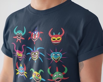 May include: A navy blue t-shirt with a colorful design of nine different masks. The masks are stylized and have a variety of colors, including red, green, blue, yellow, and purple.