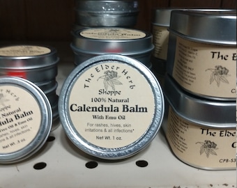 May include: A collection of small, round metal tins of Calendula Balm. The labels read "The Elder Herb Shoppe" and "100% Natural Calendula Balm with Emu Oil." The balm is for rashes, hives, skin irritations, and infections. Each tin contains 1 oz.