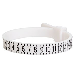 May include: White plastic ring sizer with black numbers from 1 to 15.