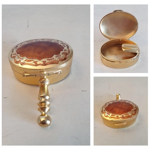 Vintage gold butler pocket ashtray with lid and holder, floral enamel design, marked 15, portable collectible tobacciana