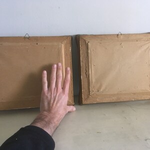 Op de afbeelding: Twee bruine fotolijsten met gouden rand en ophanghaken. De lijsten zijn leeg en hebben een getextureerd oppervlak.