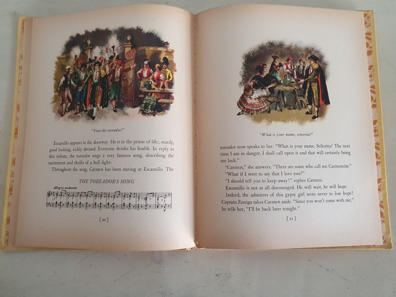 May include: An illustration from a children's book depicting a scene from the opera Carmen. The image shows a man in a red and gold costume singing to a woman in a red and black dress. The text in the image reads "What is your name, se&ntilde;orita?"