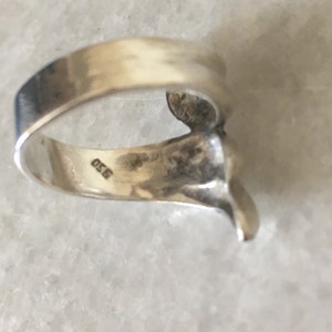 May include: Silver ring with a textured design and the number 925 stamped on the inside band.