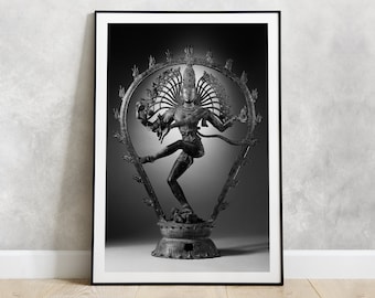 May include: Black and white photograph of a bronze statue of Shiva Nataraja, the Hindu god of dance, in a dynamic pose with multiple arms and a halo of flames.