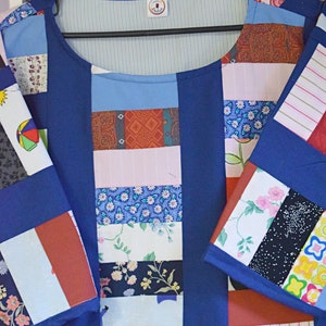 May include: A blue patchwork shirt with a variety of colorful fabrics, including floral prints, stripes, and geometric patterns. The shirt has a round neckline and short sleeves.