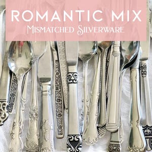 May include: An assortment of mismatched silverware, including forks, knives, and spoons, with ornate handle designs. The image features the text "ROMANTIC MIX Mismatched Silverware" in a pink banner across the top. The silverware is arranged on a white surface.