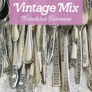 May include: A collection of mismatched vintage silverware, including forks, spoons, and knives, with ornate designs. The image features a variety of silver utensils, showcasing different patterns and styles. Text on a pink background reads "Vintage Mix Mismatched Silverware."