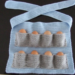 May include: A light blue crocheted egg holder with six pockets for storing eggs. The holder has a strap that can be tied around the waist.