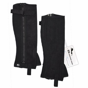 May include: A pair of black suede riding chaps with a zipper up the front and a strap with a buckle at the top. The chaps have a ribbed design and a button at the bottom.