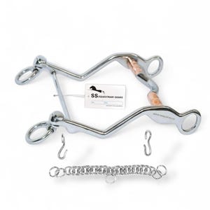 May include: A silver-colored horse bit with copper-colored accents and a chain. The bit has a curved design with rings and hooks. A tag with the text "SS Equestrian Gears" is attached.