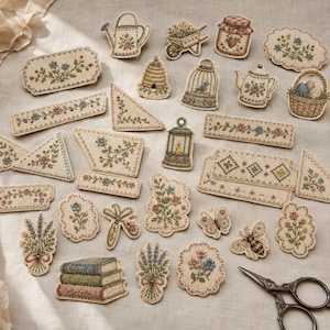 May include: A collection of embroidered fabric patches featuring various floral, garden, and nature motifs including a watering can, beehive, birdcage, books, and insects, arranged alongside a pair of vintage-style metal scissors.
