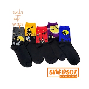May include: Five pairs of black socks with colourful Halloween-themed designs. The socks feature a haunted house, a witch, a full moon, and bats. The socks have snaps on the top to keep them together.