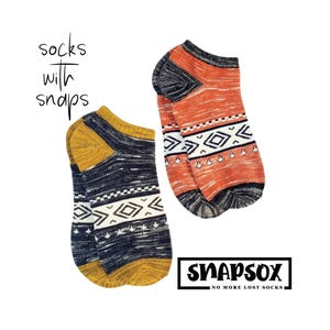 May include: Two pairs of no-show socks with geometric patterns. One pair is navy blue and gold, the other is orange and black. The socks have the text "socks with snaps" and the brand name "SNAPSox" with the tagline "NO MORE LOST SOCKS."