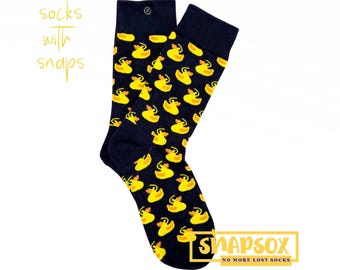 May include: A pair of dark blue socks with a pattern of yellow rubber ducks. The socks have snaps on the top to keep them together.