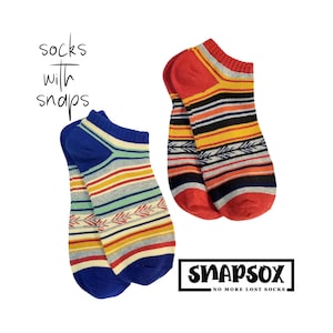 May include: Two pairs of colourful ankle socks with a striped pattern and a small arrow design. The socks are labelled "Snapsox" and "No More Lost Socks".