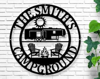 May include: Black metal sign with the text "The Smith's Campground" in a circle. The sign features a silhouette of a camper, a campfire, and two lawn chairs.