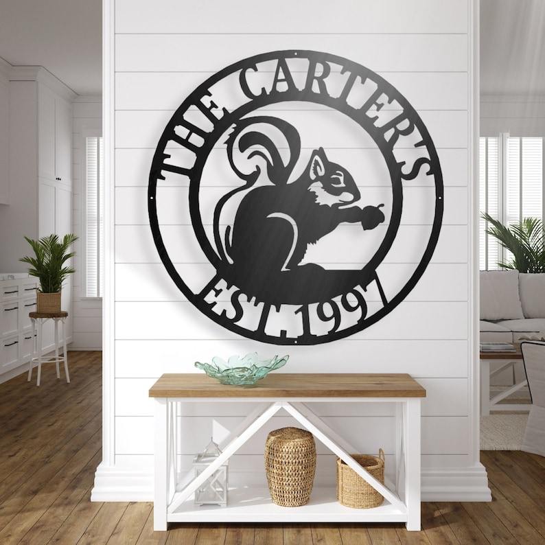 May include: Black metal wall decor featuring a squirrel silhouette with the text "The Carters Est. 1991" in a circle.
