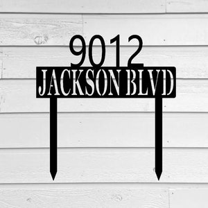May include: Black metal yard sign with the address 9012 Jackson Blvd. The sign is attached to two metal stakes.