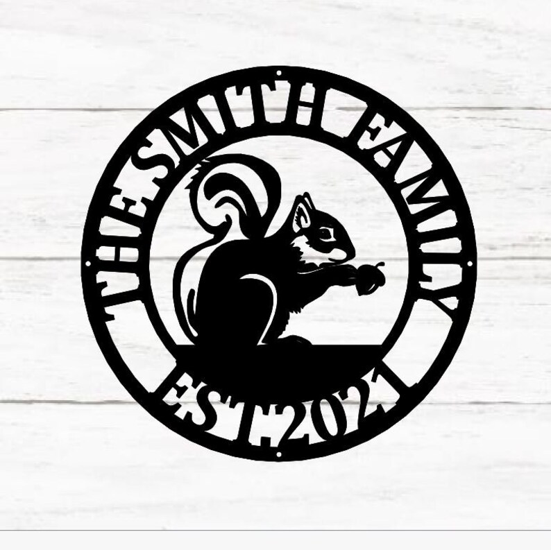 May include: Black metal sign featuring a squirrel holding a nut. The sign reads "The Smith Family Est 2021".
