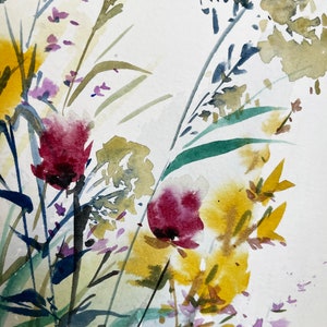 May include: A watercolor painting on textured paper featuring a botanical arrangement of wildflowers. The composition includes deep magenta blossoms, vibrant yellow clusters, and various green stems and grasses rendered in loose, fluid brushstrokes.