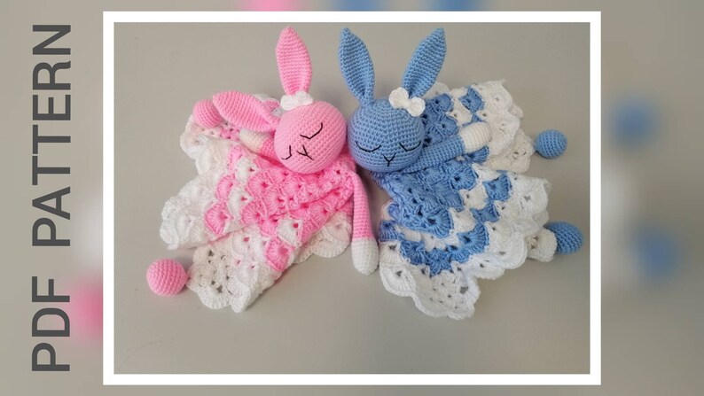 May include: Two crocheted bunny loveys, one pink and one blue, with white crocheted blankets. The bunnies have closed eyes and are lying down. The blankets have a scalloped edge.