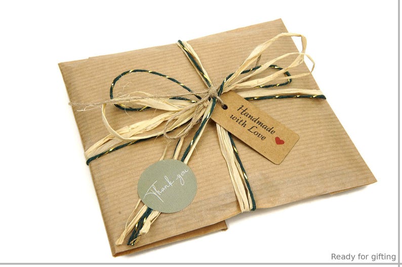 May include: A wrapped package in brown paper, tied with natural raffia and green and gold twine. A small tag reads "Handmade with Love" and a round sticker says "Thank you". The package is ready for gifting.
